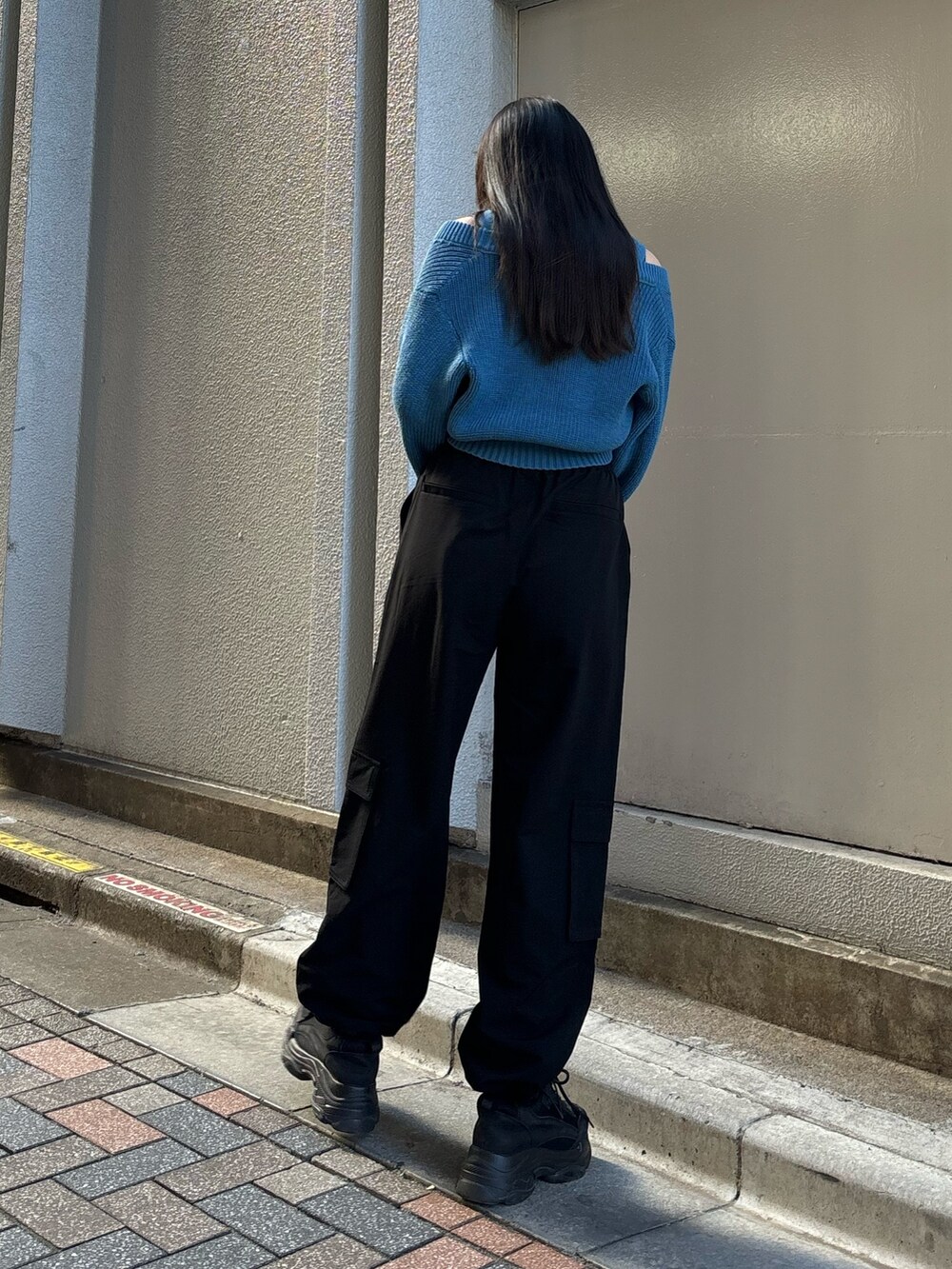 ブルー系のニット/セーター、ブラック系のスニーカー、ブラック系のその他パンツを着用したレディースの冬コーディネートの2枚目の写真