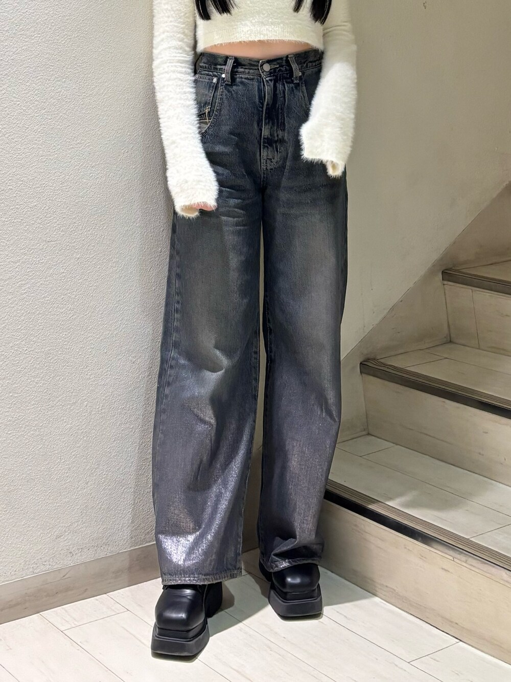 ホワイト系のニット/セーター、ブルー系のデニムパンツ、ブラック系のブーツを着用したレディースの秋コーディネートの4枚目の写真