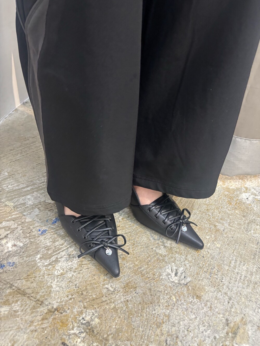 ホワイト系のパンプス、ブラック系のその他パンツ、ホワイト系のTシャツ/カットソーを着用したレディースの夏コーディネートの6枚目の写真