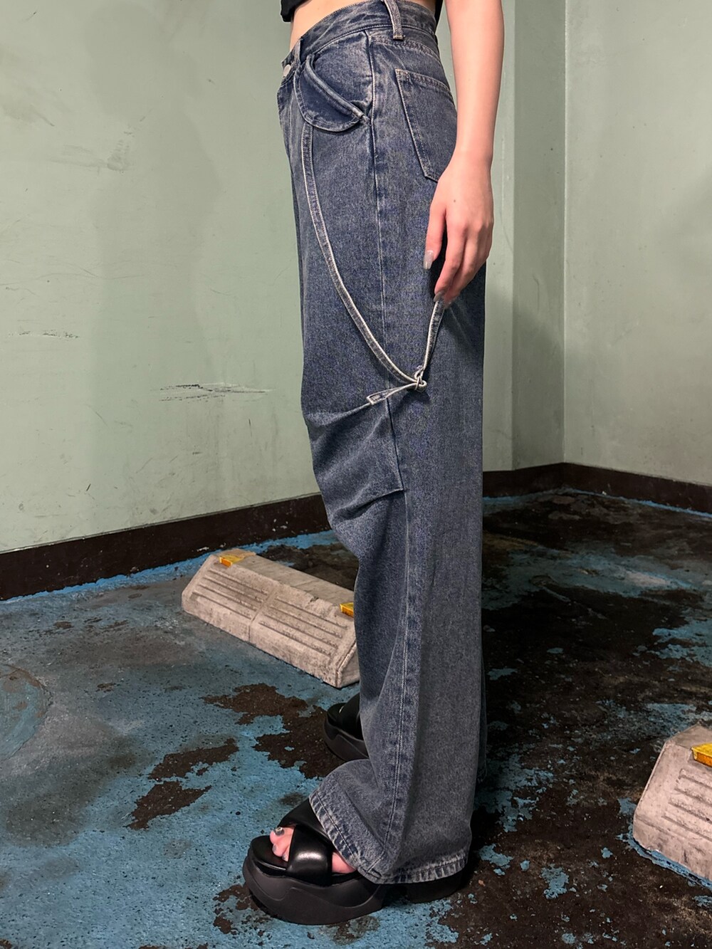 ブルー系のデニムパンツ、ブラック系のTシャツ/カットソー、ブラック系のサンダルを着用したレディースの夏コーディネートの8枚目の写真