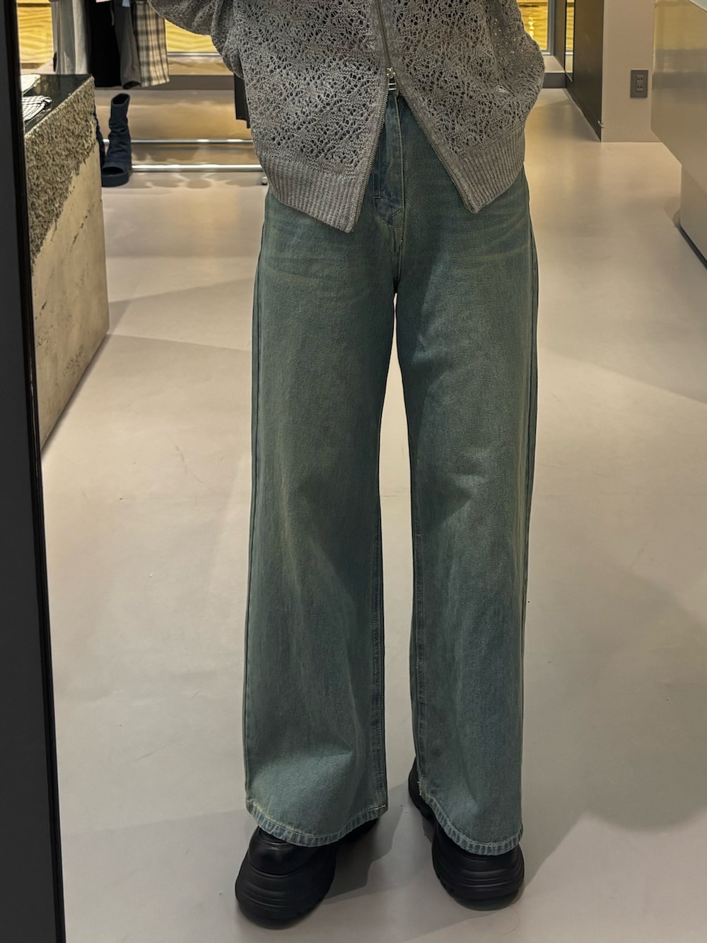 ブラック系のローファー、ベージュ系のデニムパンツ、グレー系のパーカーを着用したレディースの冬コーディネートの5枚目の写真