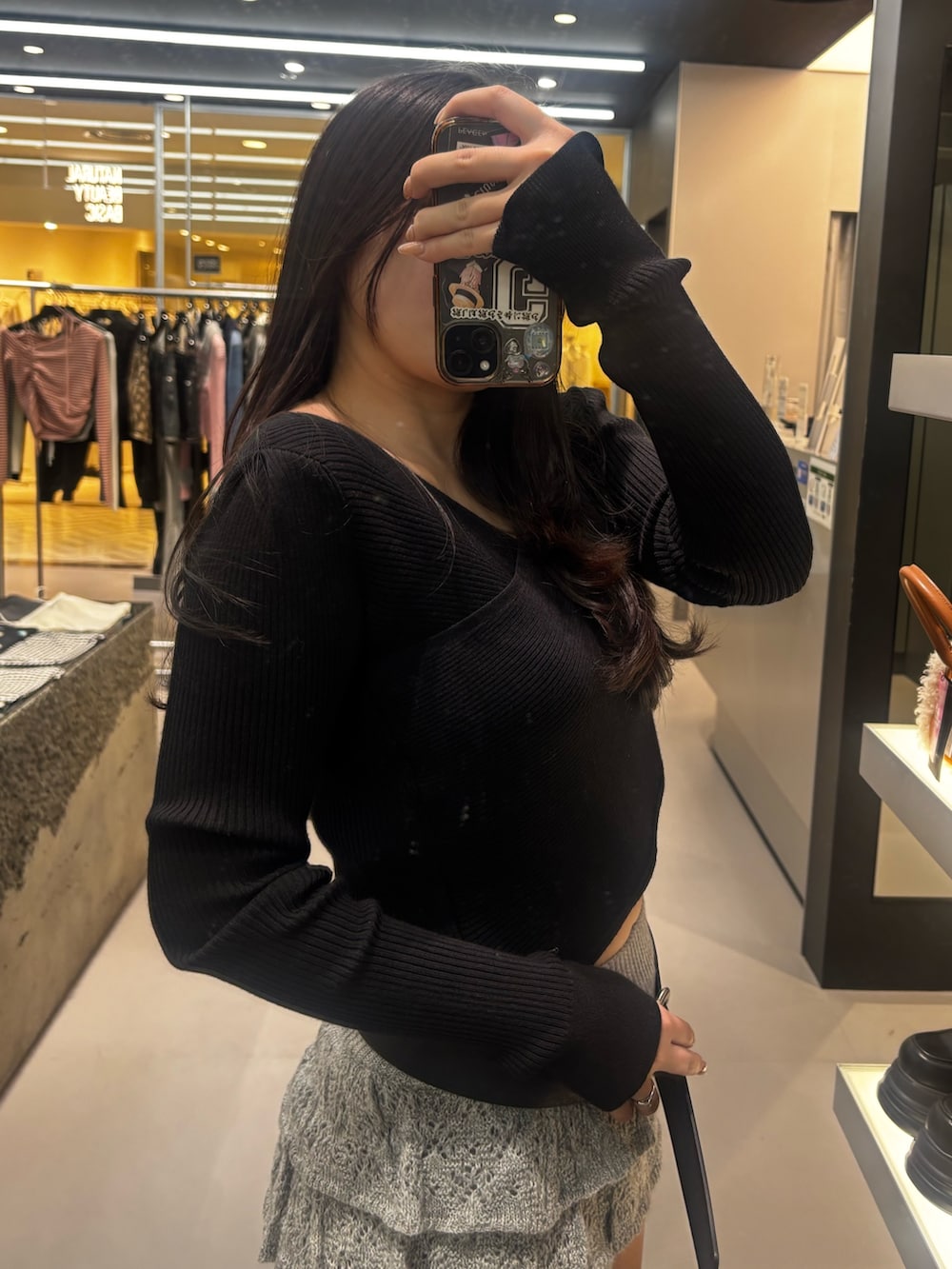 ブラック系のブーツ、グレー系のスカート、ブラック系のニット/セーターを着用したレディースの冬コーディネートの4枚目の写真