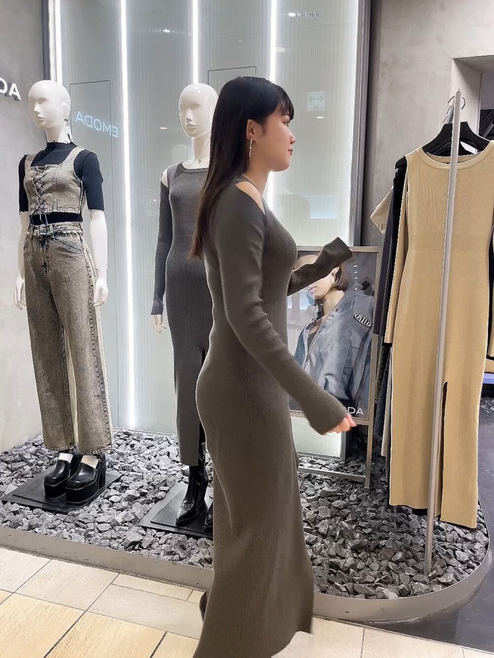 グレー系のワンピース、ブラック系のブーツを着用したレディースの春コーディネートの2枚目の写真