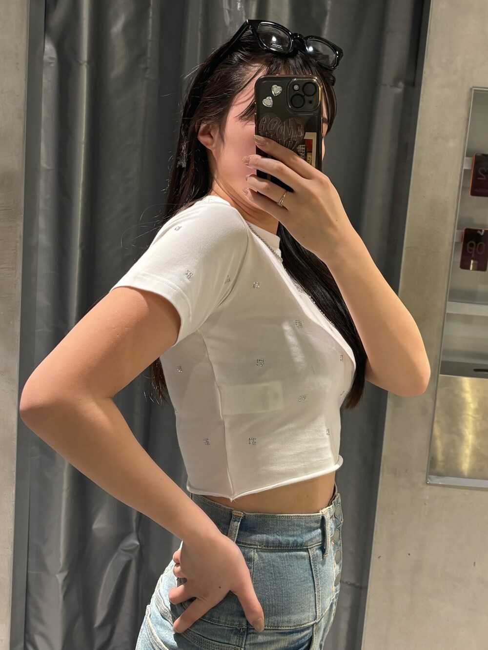 ブルー系のデニムパンツ、ブラック系のサンダル、ホワイト系のTシャツ/カットソーを着用したレディースの春コーディネートの4枚目の写真