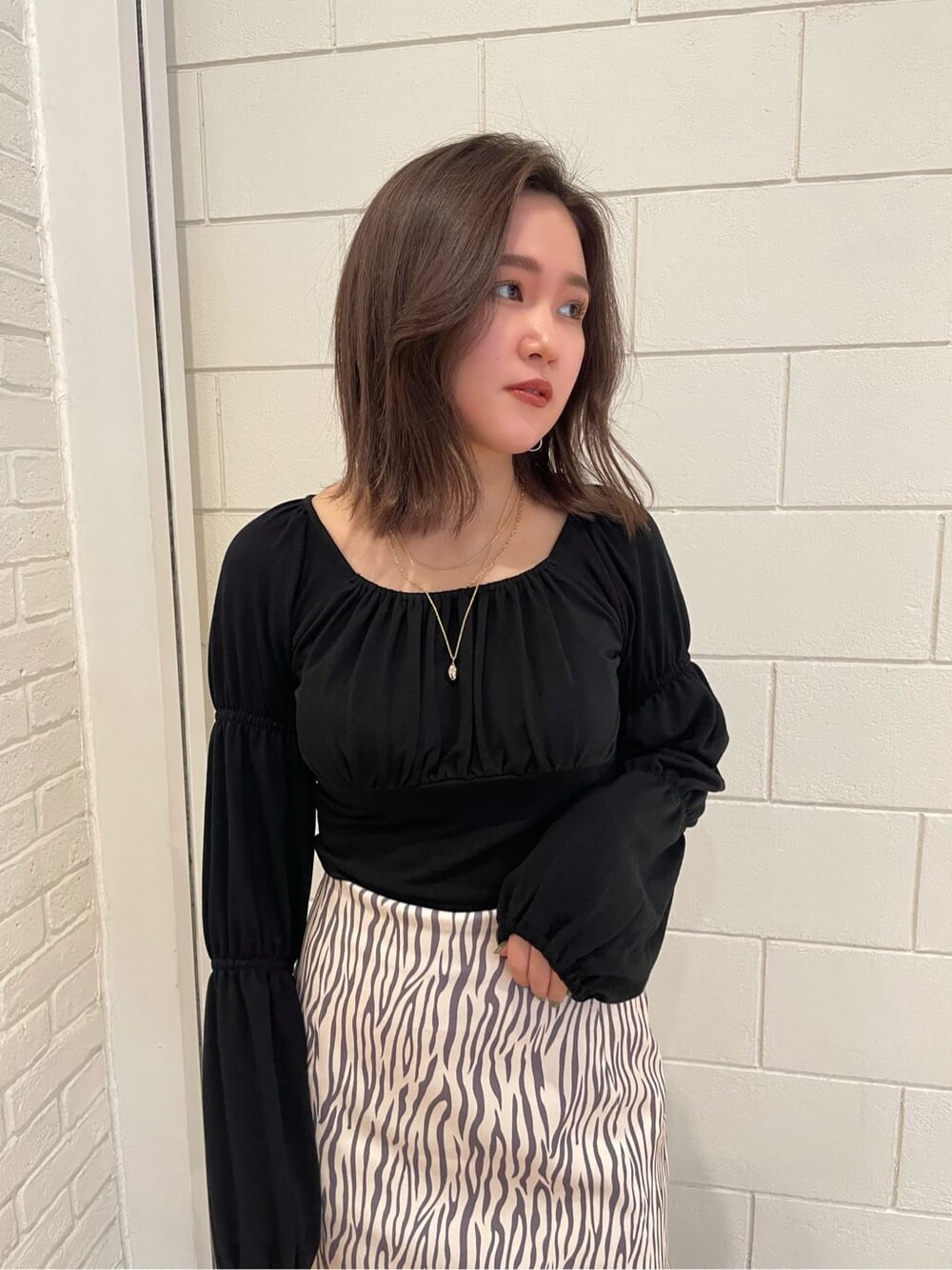 ブラック系のブーツ、ブラック系のTシャツ/カットソー、その他のスカートを着用したレディースの春コーディネートの5枚目の写真