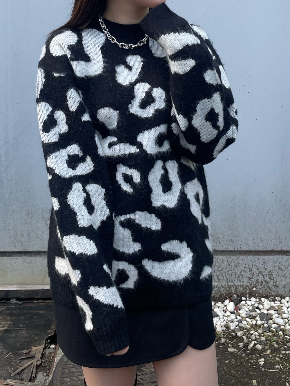 ブラック系のニット/セーター、ブラック系のスカート、ブラック系のブーツを着用したレディースの冬コーディネートの3枚目の写真