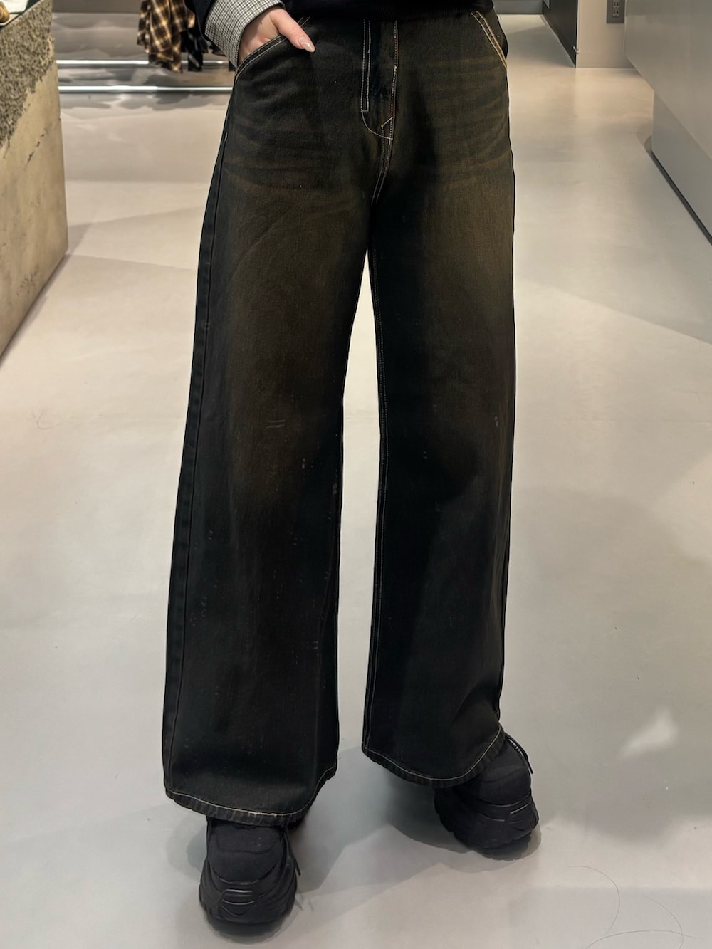 ベージュ系のデニムパンツ、ブラック系のシャツ/ブラウス、ブラック系のスニーカーを着用したレディースの冬コーディネートの5枚目の写真