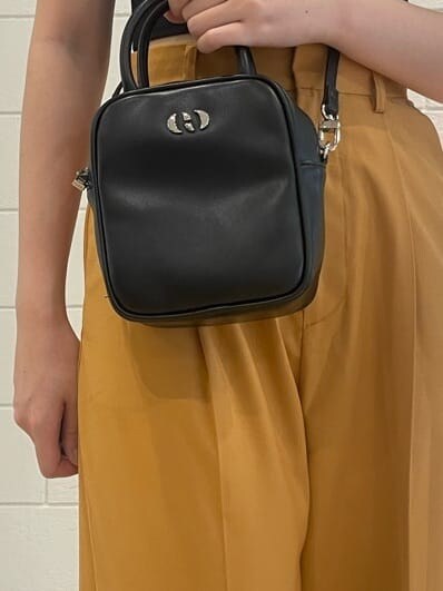 ブラック系のショルダーバッグ、オレンジ系のその他パンツ、ブラック系のサンダルを着用したレディースの夏コーディネートの7枚目の写真