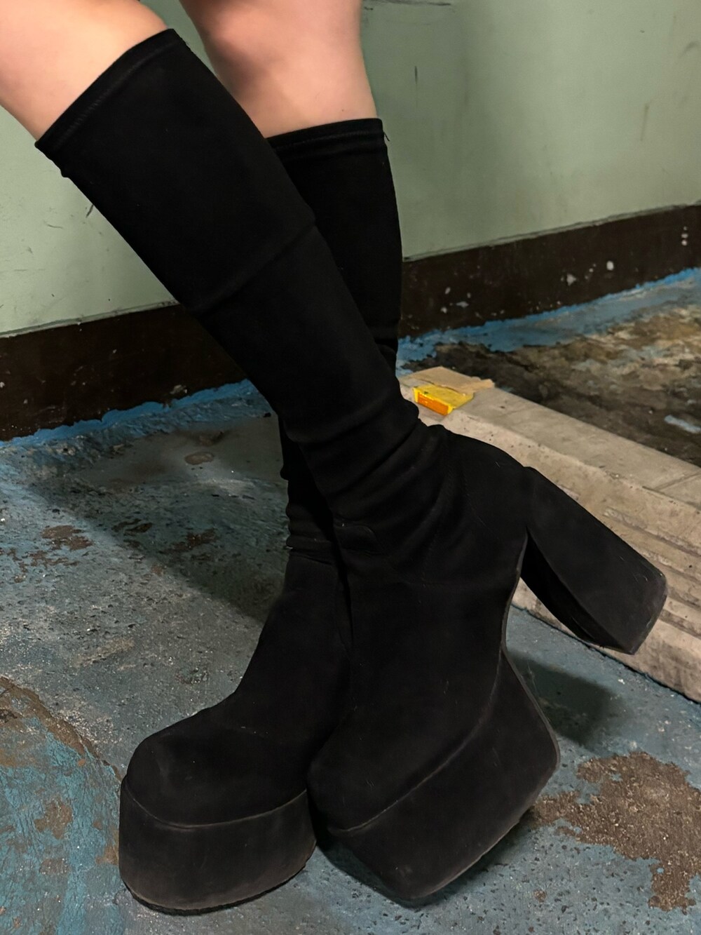 ブラック系のブルゾン、グレー系のワンピース、その他のブーツを着用したレディースの冬コーディネートの9枚目の写真