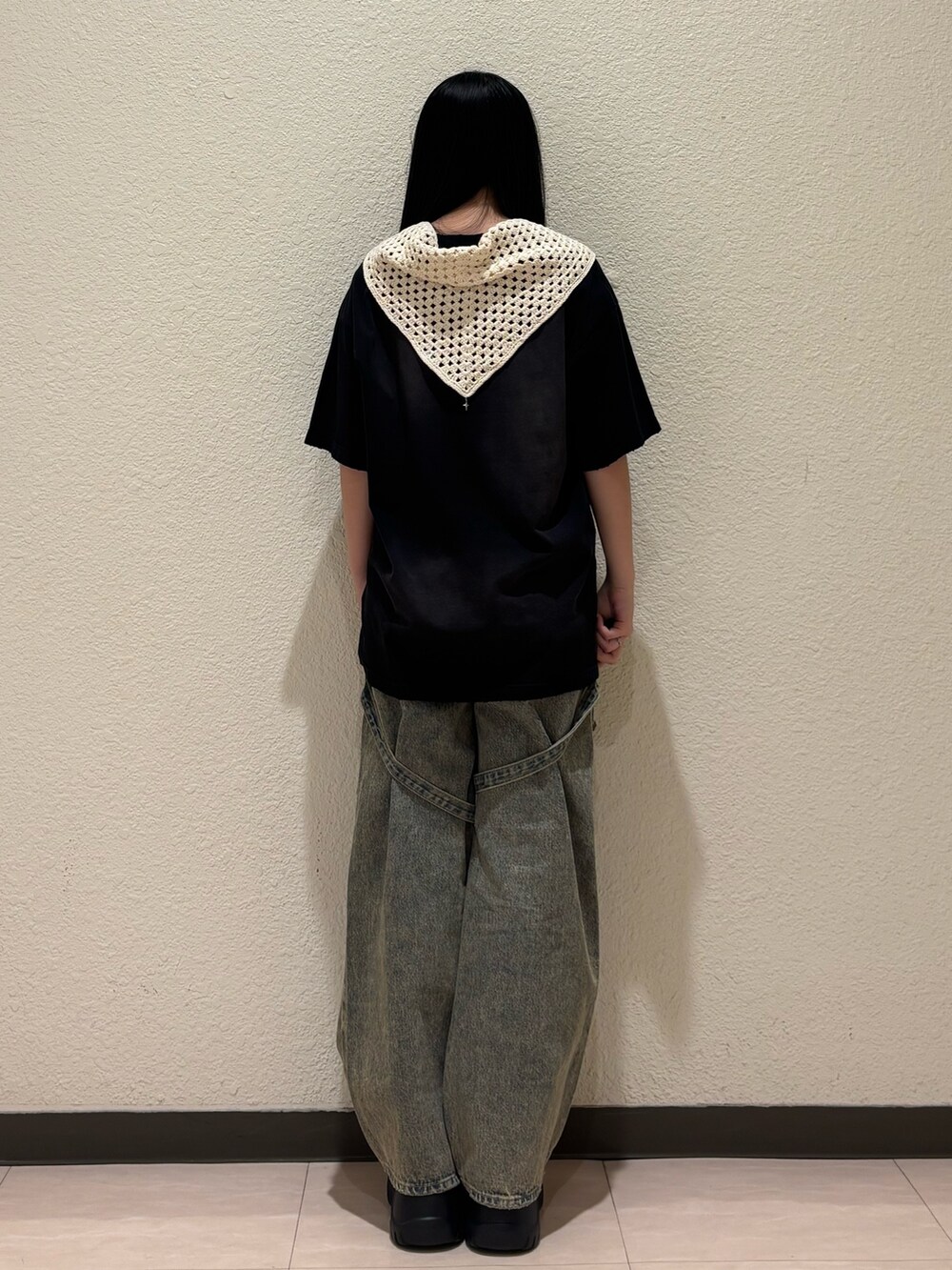 ブラック系のスニーカー、ベージュ系のデニムパンツ、ブラック系のTシャツ/カットソーを着用したレディースの春コーディネートの3枚目の写真