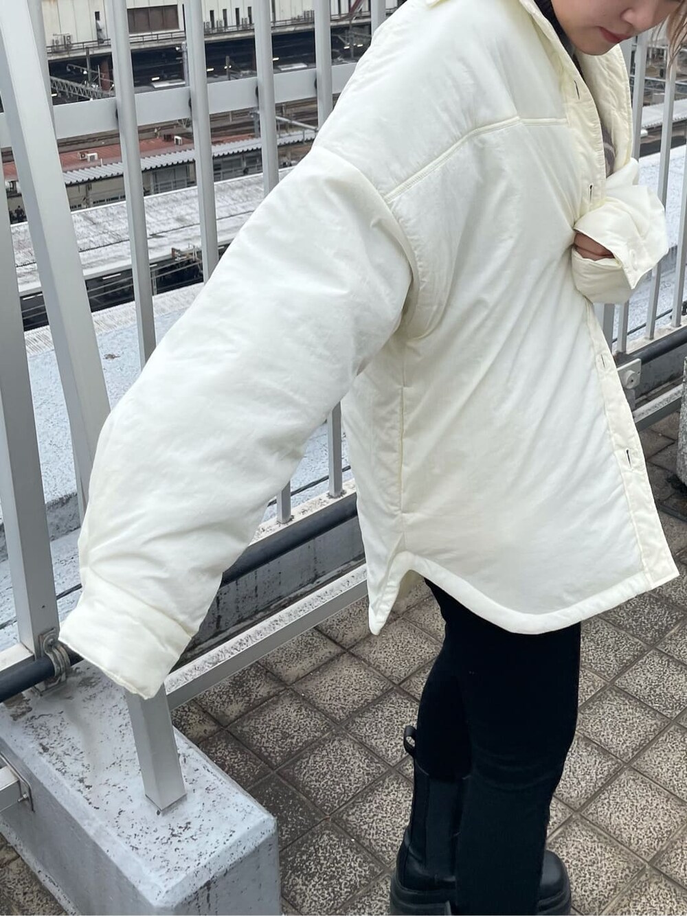 ブラック系のデニムパンツ、ホワイト系のブルゾン、その他のニット/セーターを着用したレディースの秋コーディネートの6枚目の写真