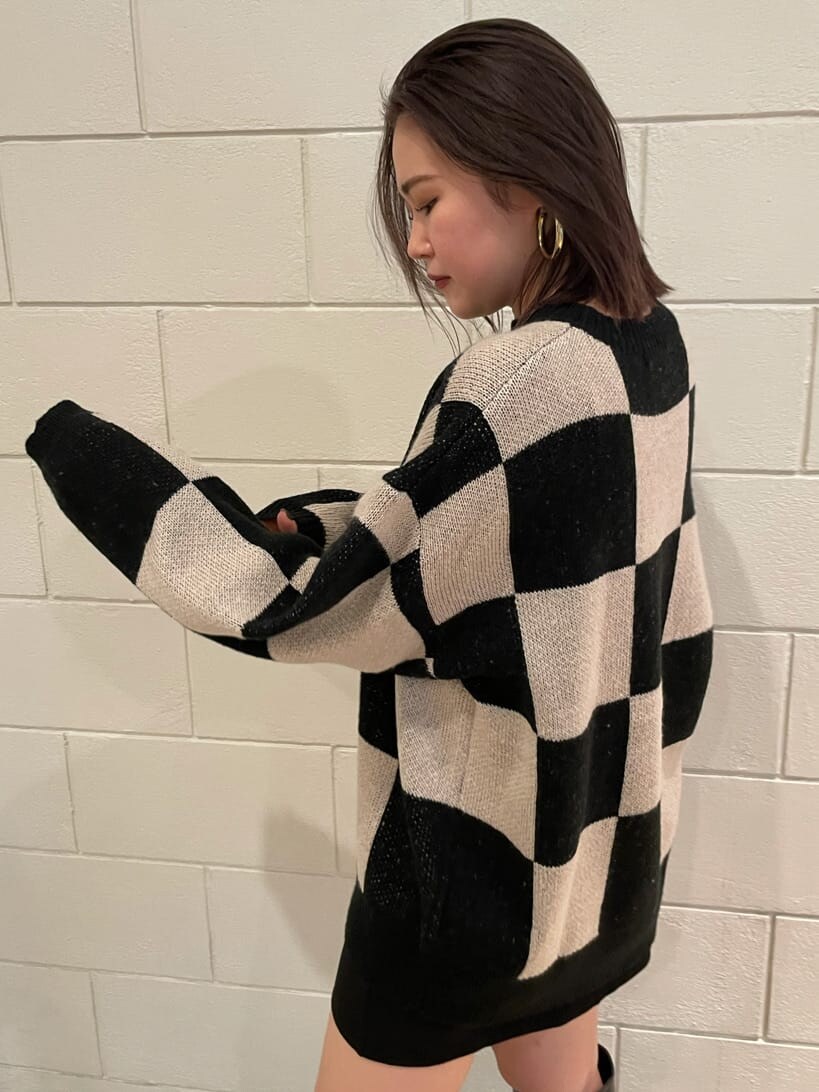 ブラック系のブーツ、ブラック系のスカート、ブラック系のニット/セーターを着用したレディースの冬コーディネートの6枚目の写真