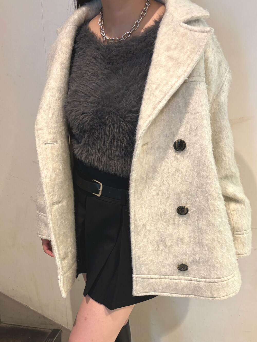 その他のブーツ、ホワイト系のピーコート、グレー系のニット/セーターを着用したレディースの秋コーディネートの7枚目の写真