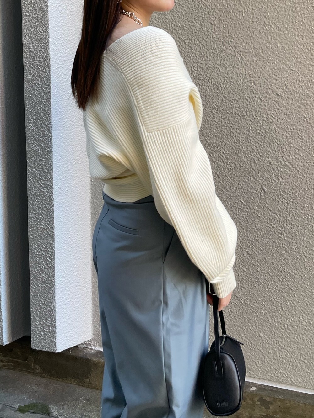 ホワイト系のニット/セーター、ブルー系のその他パンツ、ブラック系のブーツを着用したレディースの冬コーディネートの5枚目の写真