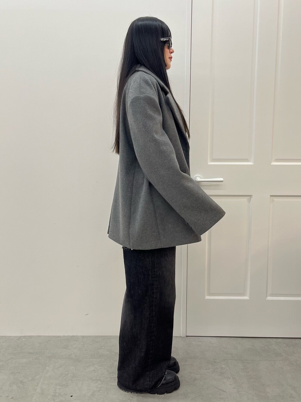 ブルー系のデニムパンツ、ブラック系のブーツ、その他のTシャツ/カットソーを着用したレディースの夏コーディネートの2枚目の写真