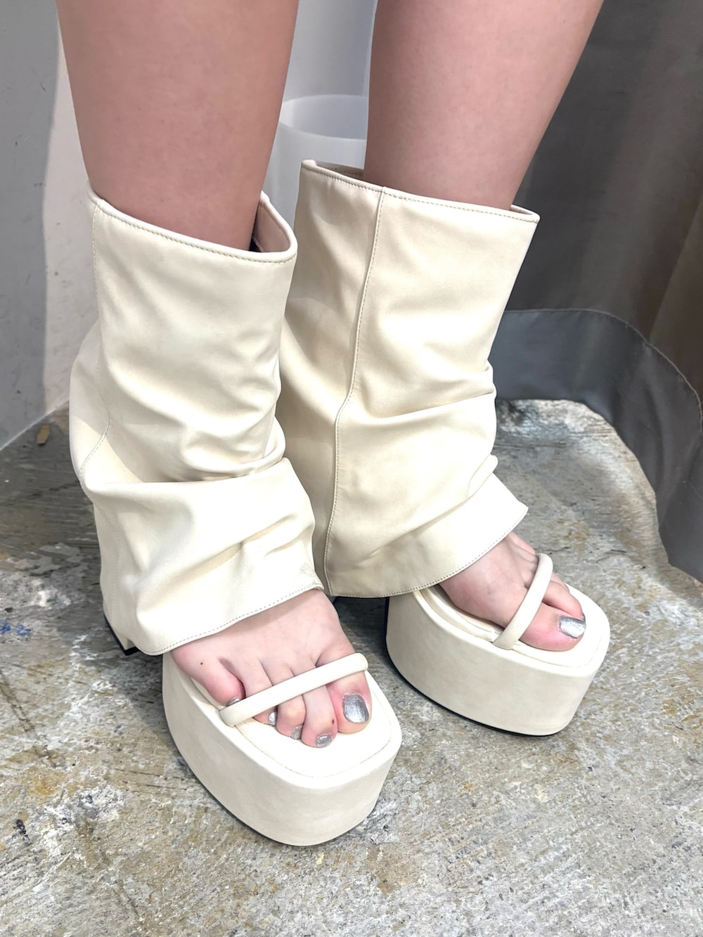 ブラック系のサンダル、ホワイト系のニット/セーター、グレー系のスカートを着用したレディースの夏コーディネートの5枚目の写真