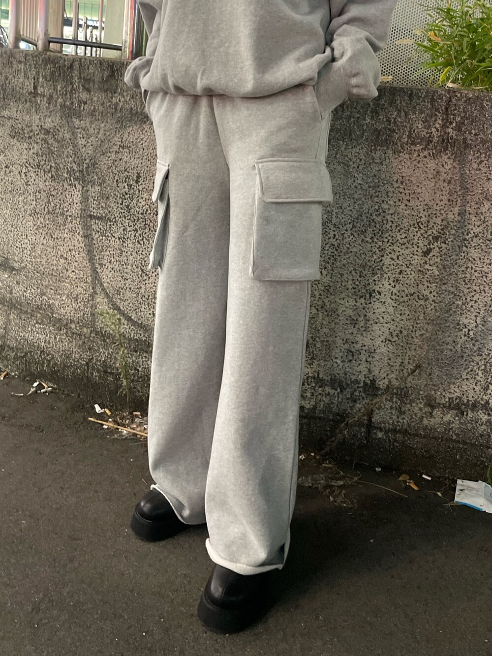 グレー系のTシャツ/カットソー、グレー系のスウェットパンツ、ブラック系のブーツを着用したレディースの秋コーディネートの6枚目の写真