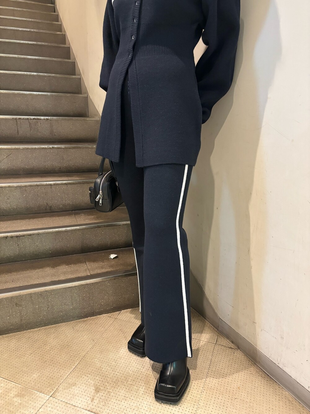 ブルー系のカーディガン/ボレロ、ブルー系のその他パンツ、ブラック系のブーツを着用したレディースの秋コーディネートの5枚目の写真