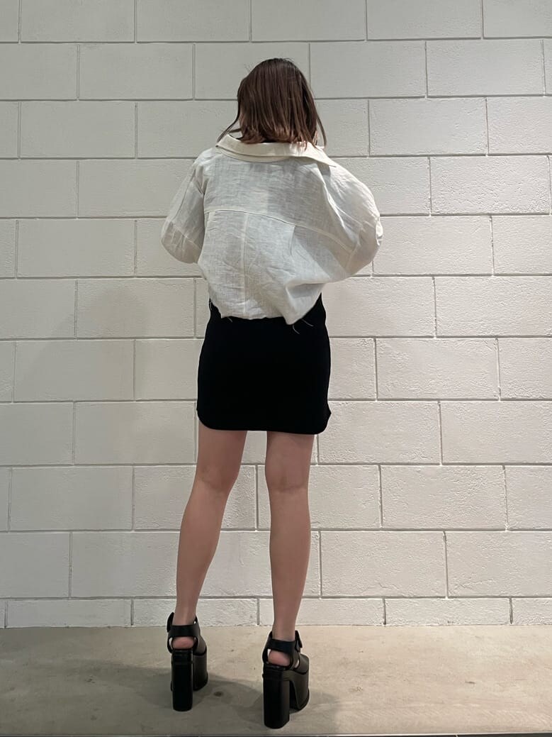 ブラック系のワンピース、ホワイト系のブルゾン、ブラック系のサンダルを着用したレディースの春コーディネートの3枚目の写真