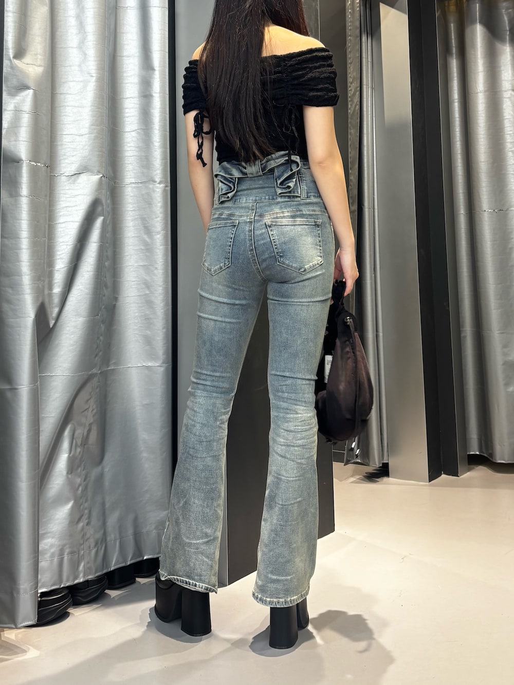 ホワイト系のサンダル、ブルー系のデニムパンツ、ブラウン系のショルダーバッグを着用したレディースの夏コーディネートの3枚目の写真