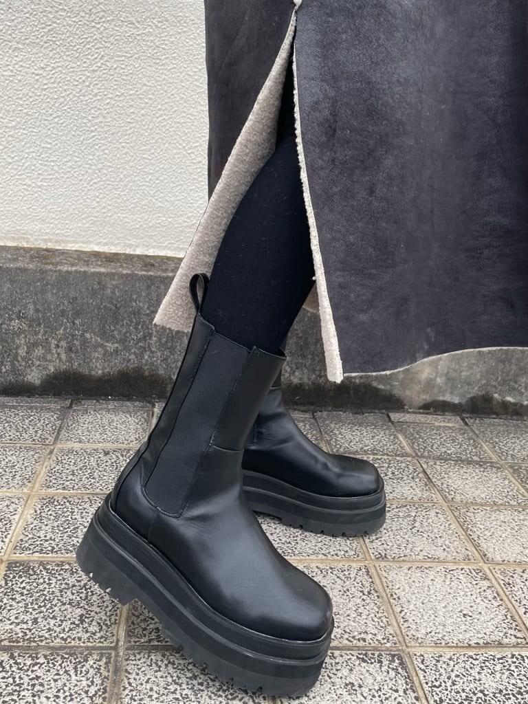 ブラック系のTシャツ/カットソー、ブラック系のデニムパンツ、ブラック系のムートンコートを着用したレディースの秋コーディネートの5枚目の写真