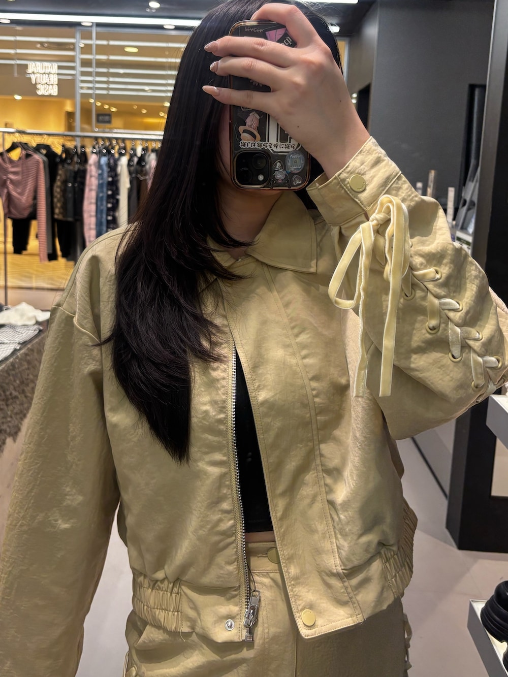 ブラック系のブーツ、イエロー系のスカート、イエロー系のブルゾンを着用したレディースの冬コーディネートの3枚目の写真