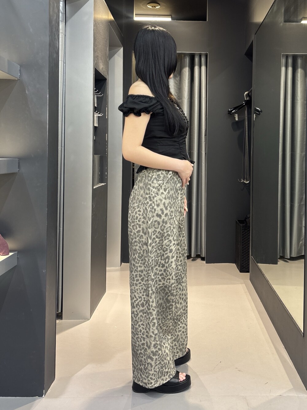 ベージュ系のその他パンツ、ブラック系のシャツ/ブラウス、ブラック系のサンダルを着用したレディースの夏コーディネートの2枚目の写真