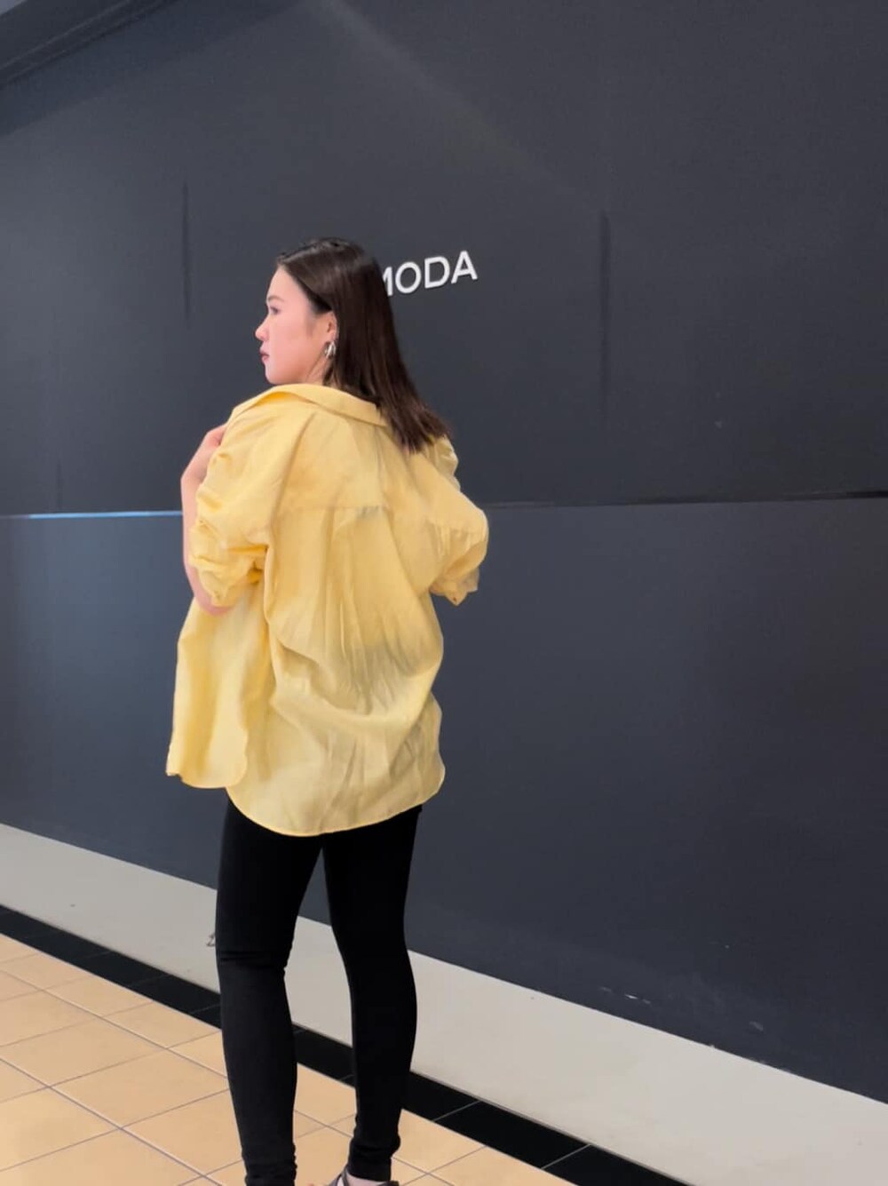 ブラック系のサンダル、ブラック系のデニムパンツ、ホワイト系のタンクトップを着用したレディースの夏コーディネートの2枚目の写真