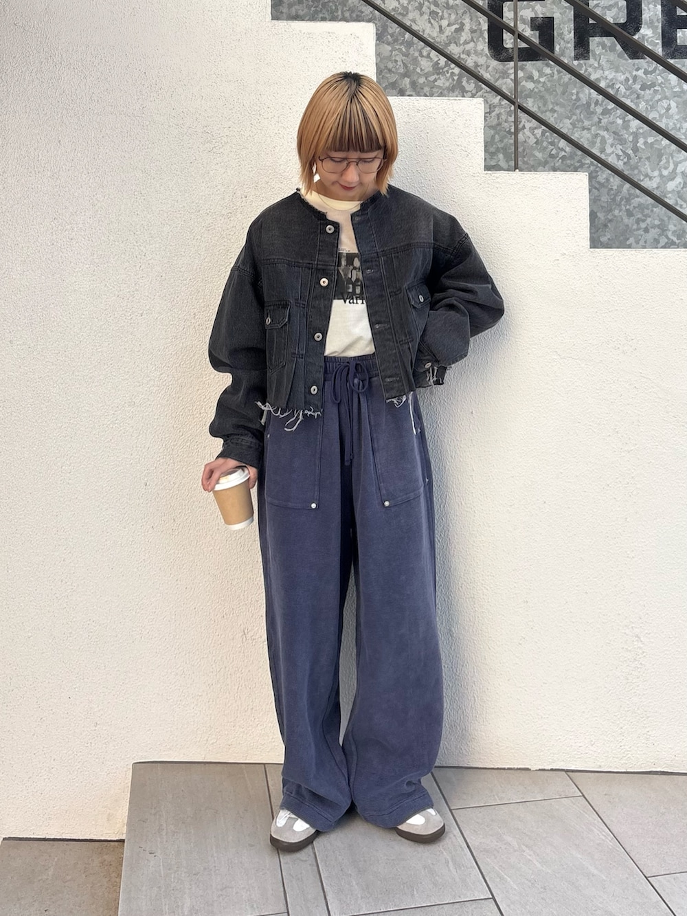 ブラック系のデニムジャケット、ホワイト系のTシャツ/カットソー、ブルー系のスウェットパンツを着用したレディースの春コーディネートの2枚目の写真