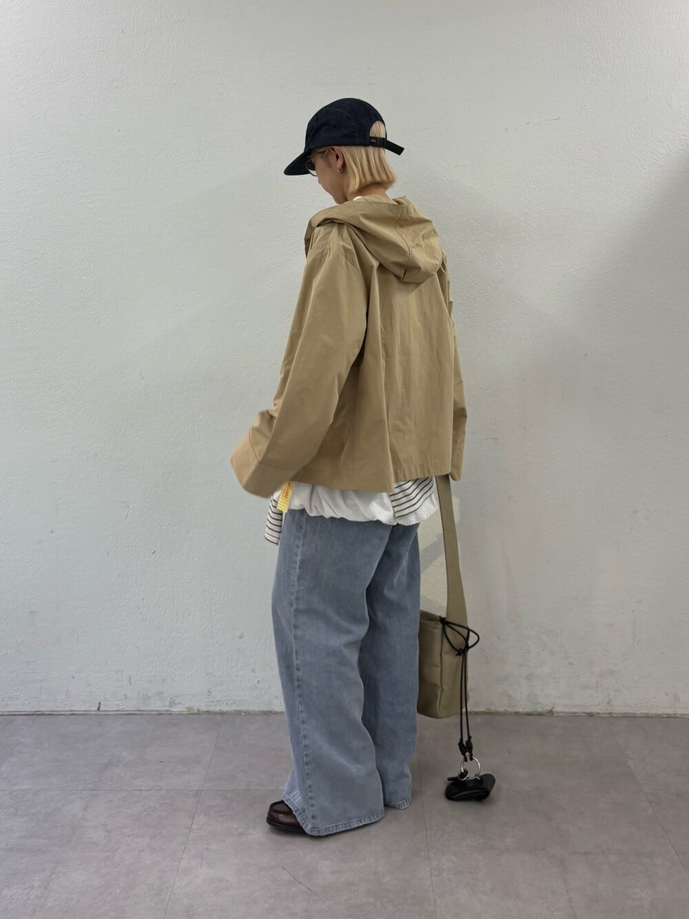 ブルー系のデニムパンツ、ホワイト系のシャツ/ブラウス、ホワイト系のTシャツ/カットソーを着用したレディースの春コーディネートの2枚目の写真