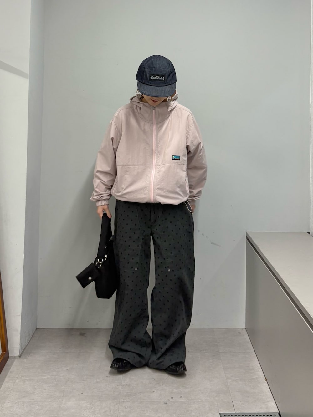 グレー系のその他パンツ、ブラック系のショルダーバッグ、ピンク系のパーカーを着用したレディースの冬コーディネートの2枚目の写真