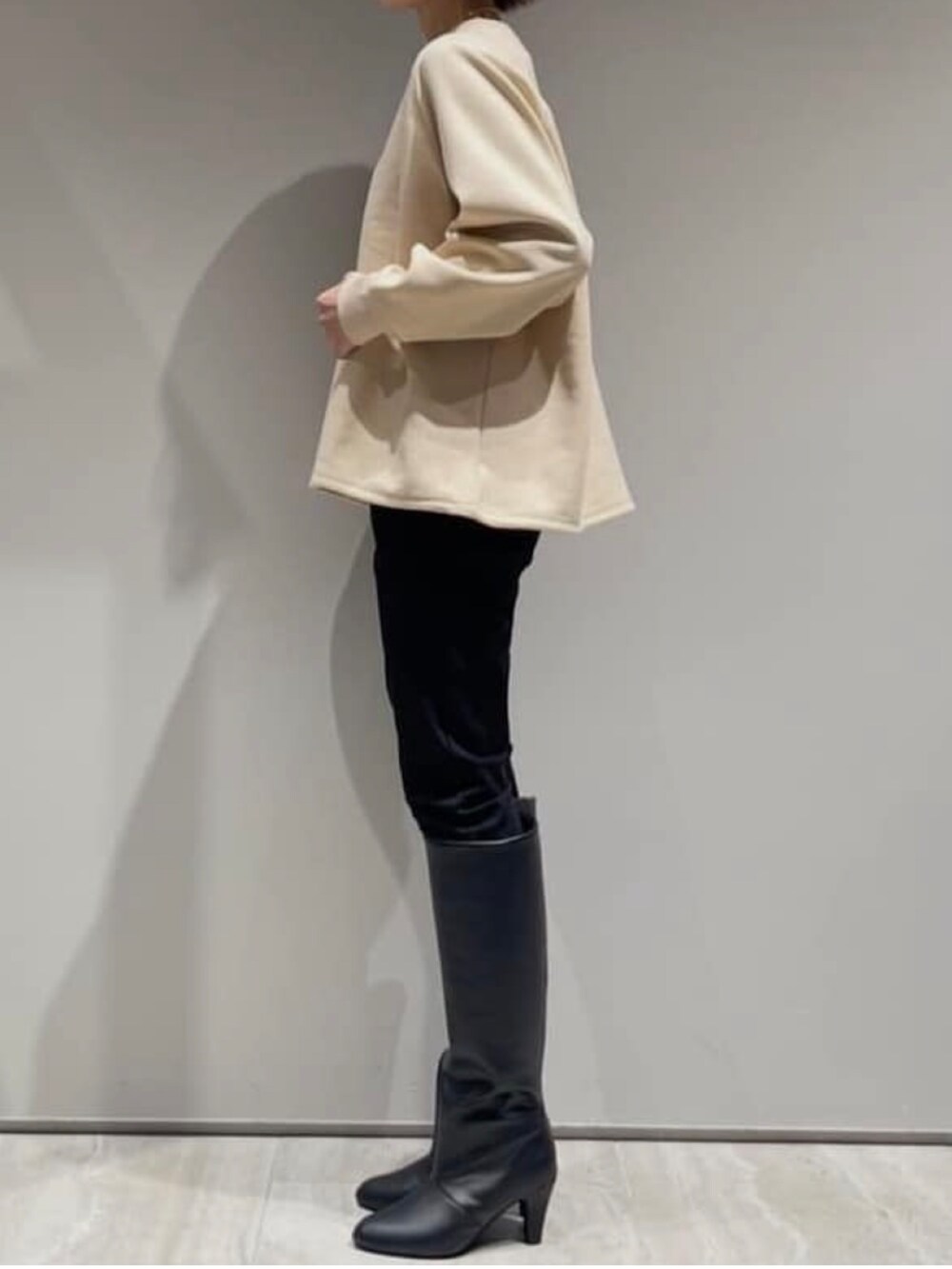 ブラック系のその他パンツ、ブラック系のダウンジャケット/コート、ベージュ系のスウェットを着用したレディースの冬コーディネートの7枚目の写真