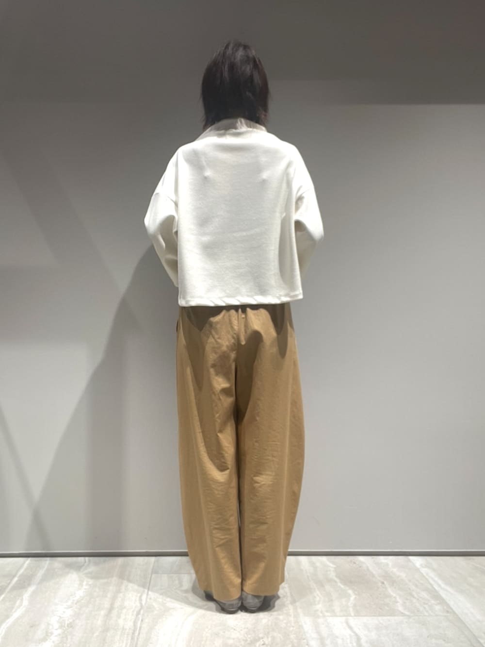 ホワイト系のTシャツ/カットソー、ベージュ系のカーゴパンツ、ホワイト系のショルダーバッグを着用したレディースの秋コーディネートの4枚目の写真