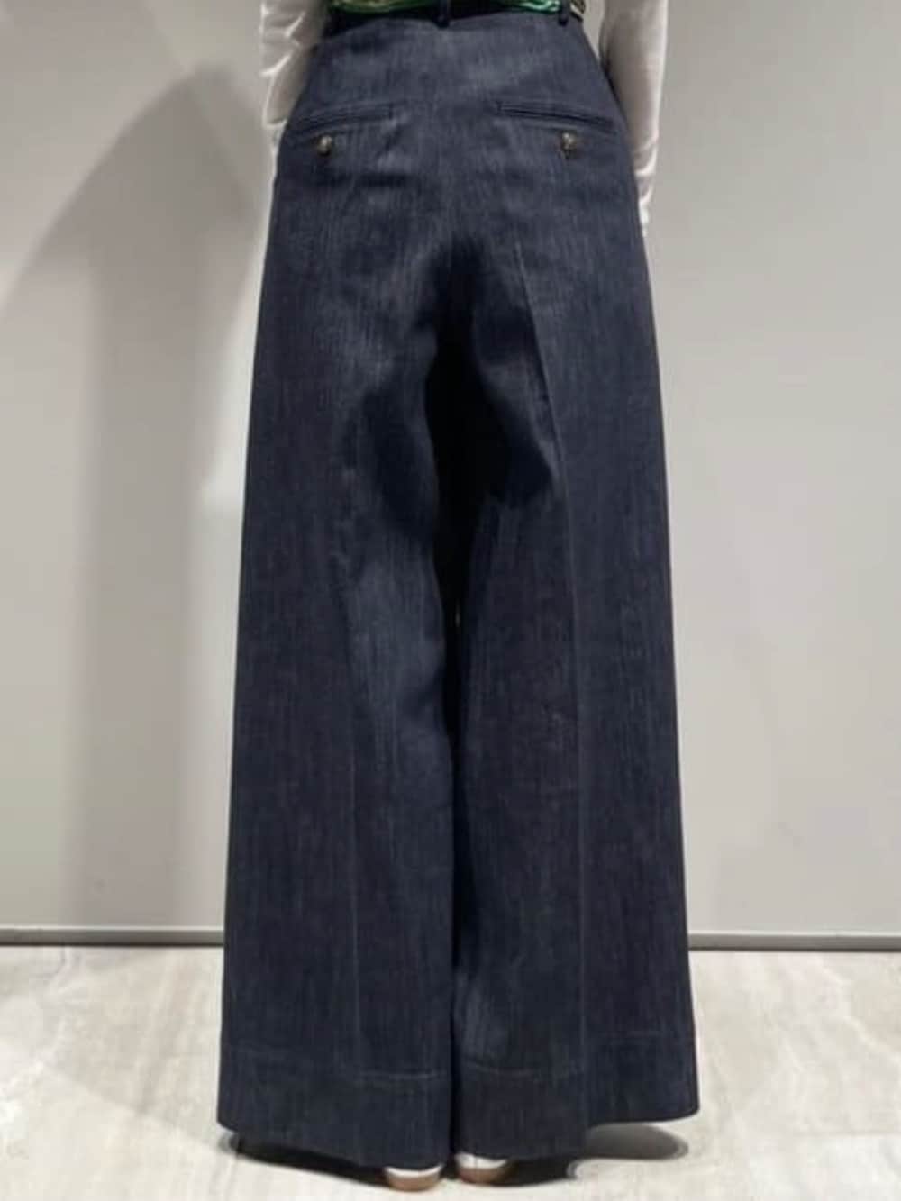 ブルー系のデニムパンツ、ホワイト系のショルダーバッグ、ホワイト系のTシャツ/カットソーを着用したレディースの冬コーディネートの5枚目の写真