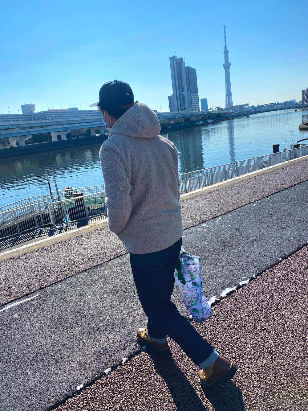 ベージュ系のその他アウター、ブルー系のデニムパンツ、ベージュ系のブーツを着用したメンズの冬コーディネートの2枚目の写真