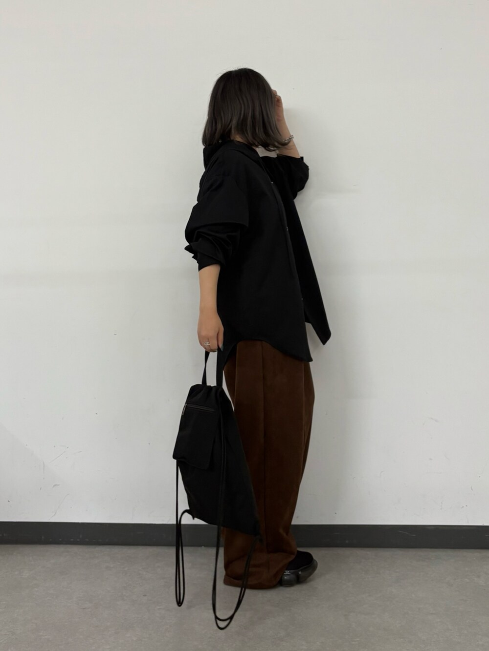 ブラック系のシャツ/ブラウス、シルバー系のシャツ/ブラウス、ブラック系のバックパック/リュックを着用したレディースの秋コーディネートの2枚目の写真