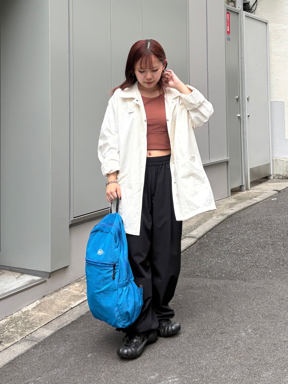 ブラック系のその他パンツ、ブラック系のバックパック/リュック、ブラウン系のタンクトップを着用したレディースの夏コーディネートの4枚目の写真