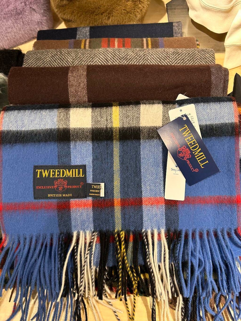 グリーン系のニット/セーター、ブルー系のマフラーを着用したレディースの冬コーディネートの2枚目の写真