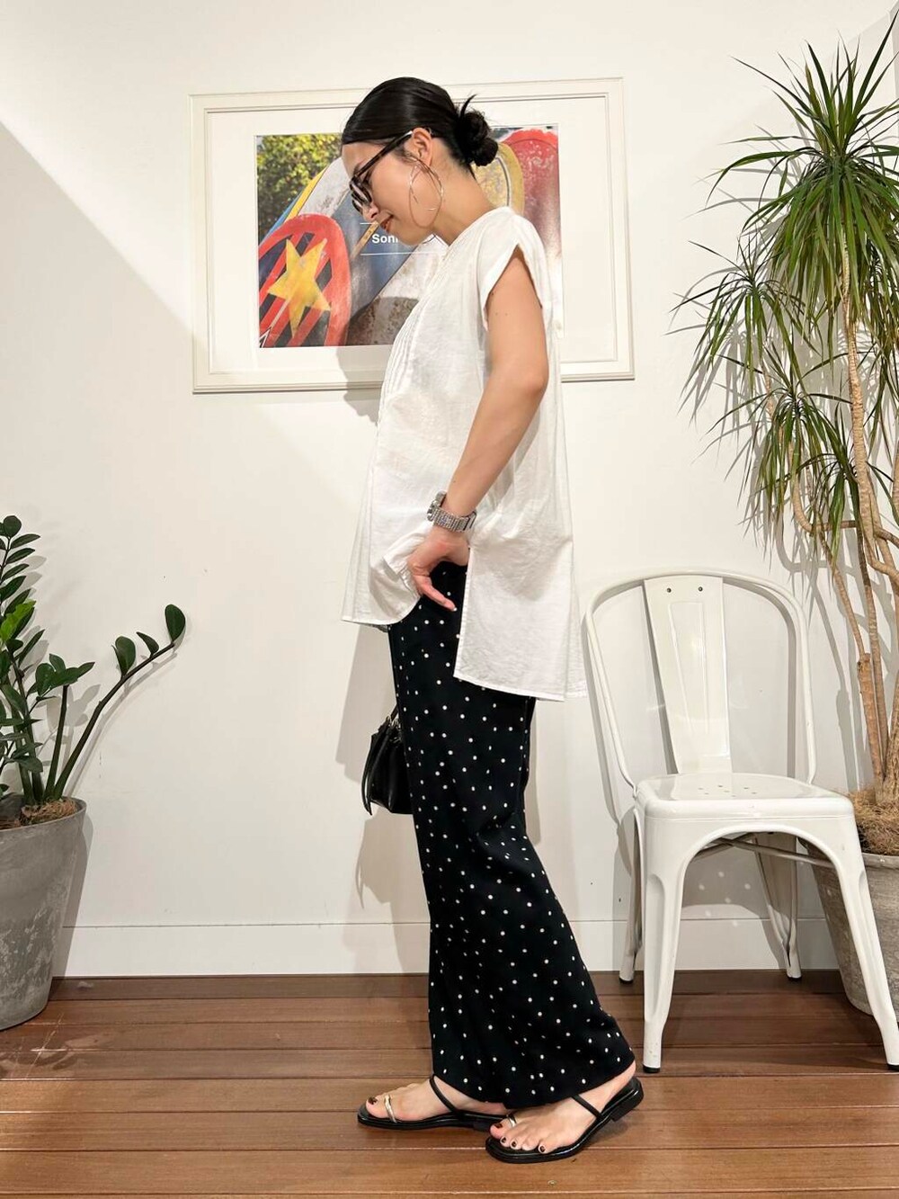ブラック系のハンドバッグ、ブラック系のその他パンツ、ホワイト系のTシャツ/カットソーを着用したレディースの夏コーディネートの4枚目の写真