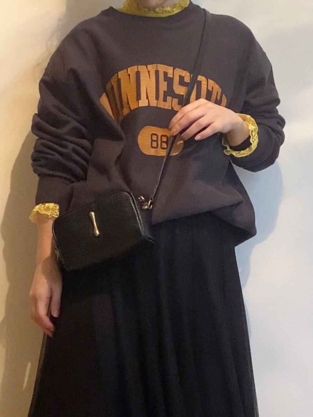 ベージュ系のスニーカー、ブラック系のショルダーバッグ、ブラウン系のスウェットを着用したレディースの春コーディネートの2枚目の写真