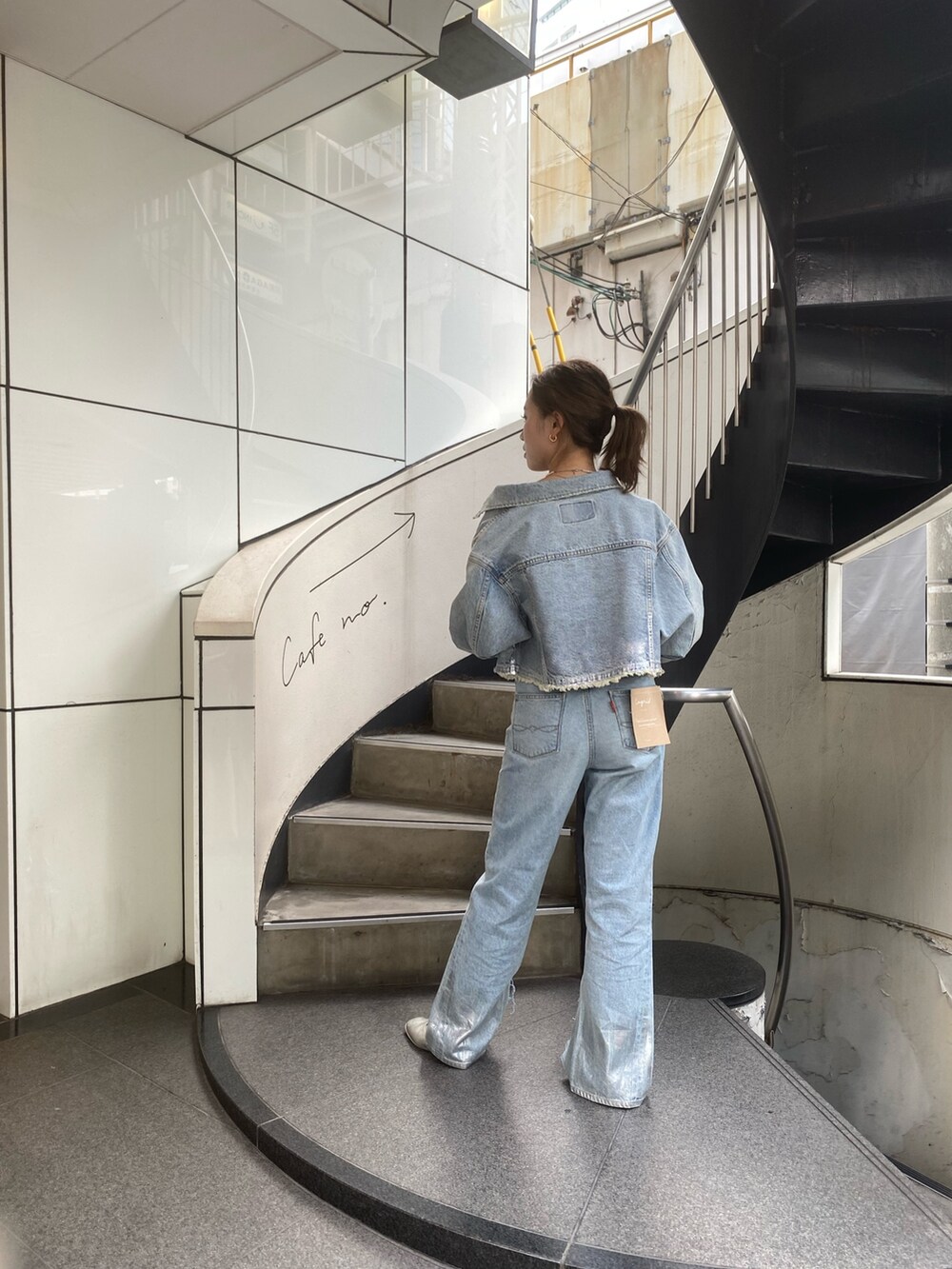 ブルー系のデニムジャケット、ブルー系のデニムパンツを着用したレディースの夏コーディネートの3枚目の写真