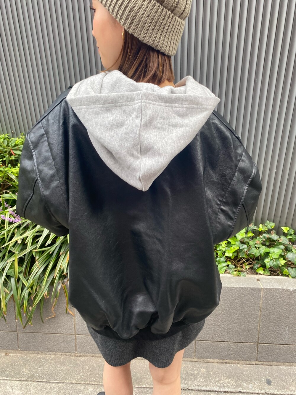 グレー系のスカート、ブラック系のブルゾン、グレー系のパーカーを着用したレディースの秋コーディネートの6枚目の写真