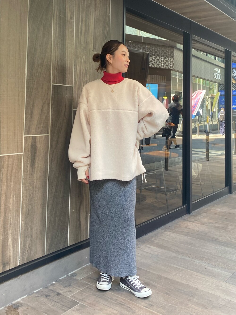ホワイト系のTシャツ/カットソー、グレー系のスカート、レッド系のニット/セーターを着用したレディースの秋コーディネートの2枚目の写真