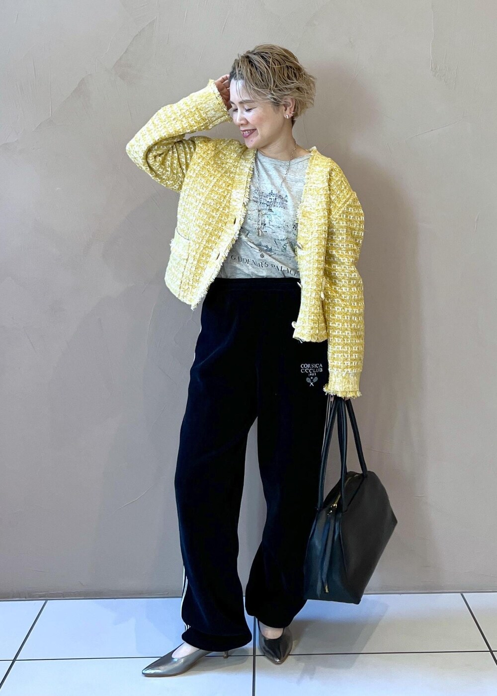 イエロー系のカーディガン/ボレロ、ブラック系のカーディガン/ボレロ、グレー系のTシャツ/カットソーを着用したレディースの冬コーディネートの2枚目の写真