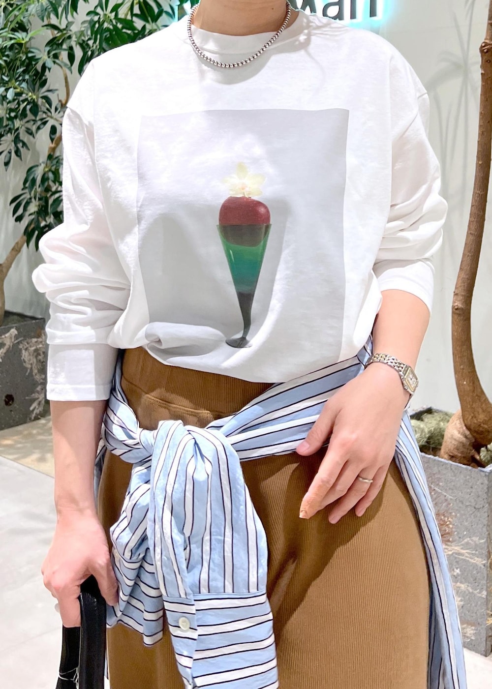 ブラック系のトートバッグ、ブルー系のシャツ/ブラウス、ホワイト系のTシャツ/カットソーを着用したレディースの冬コーディネートの7枚目の写真