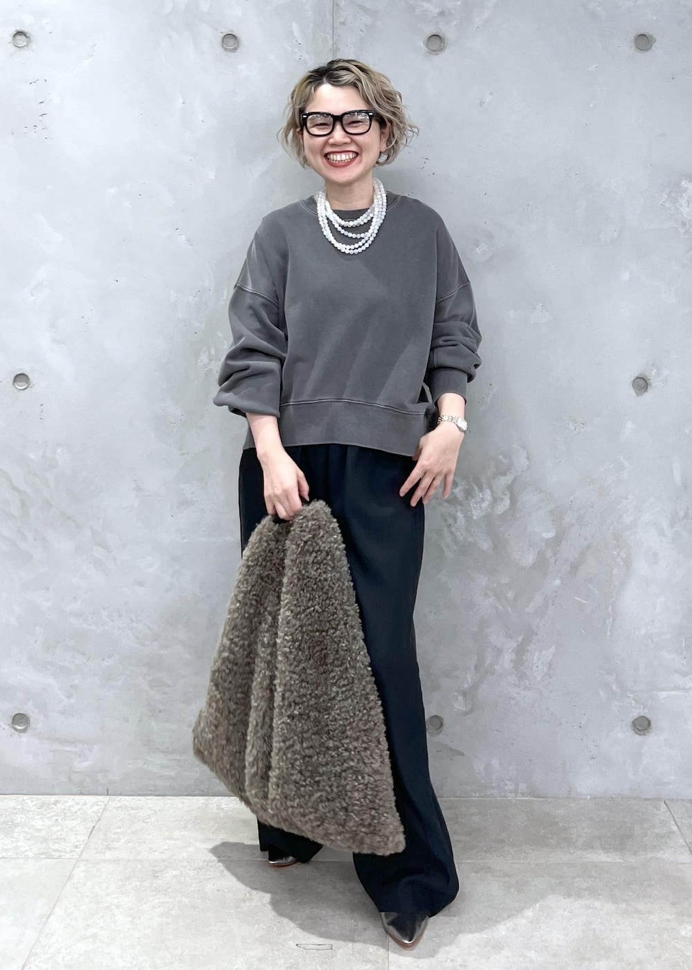 ブラック系のその他パンツ、グレー系のスウェット、ブラウン系のトートバッグを着用したレディースの秋コーディネートの2枚目の写真