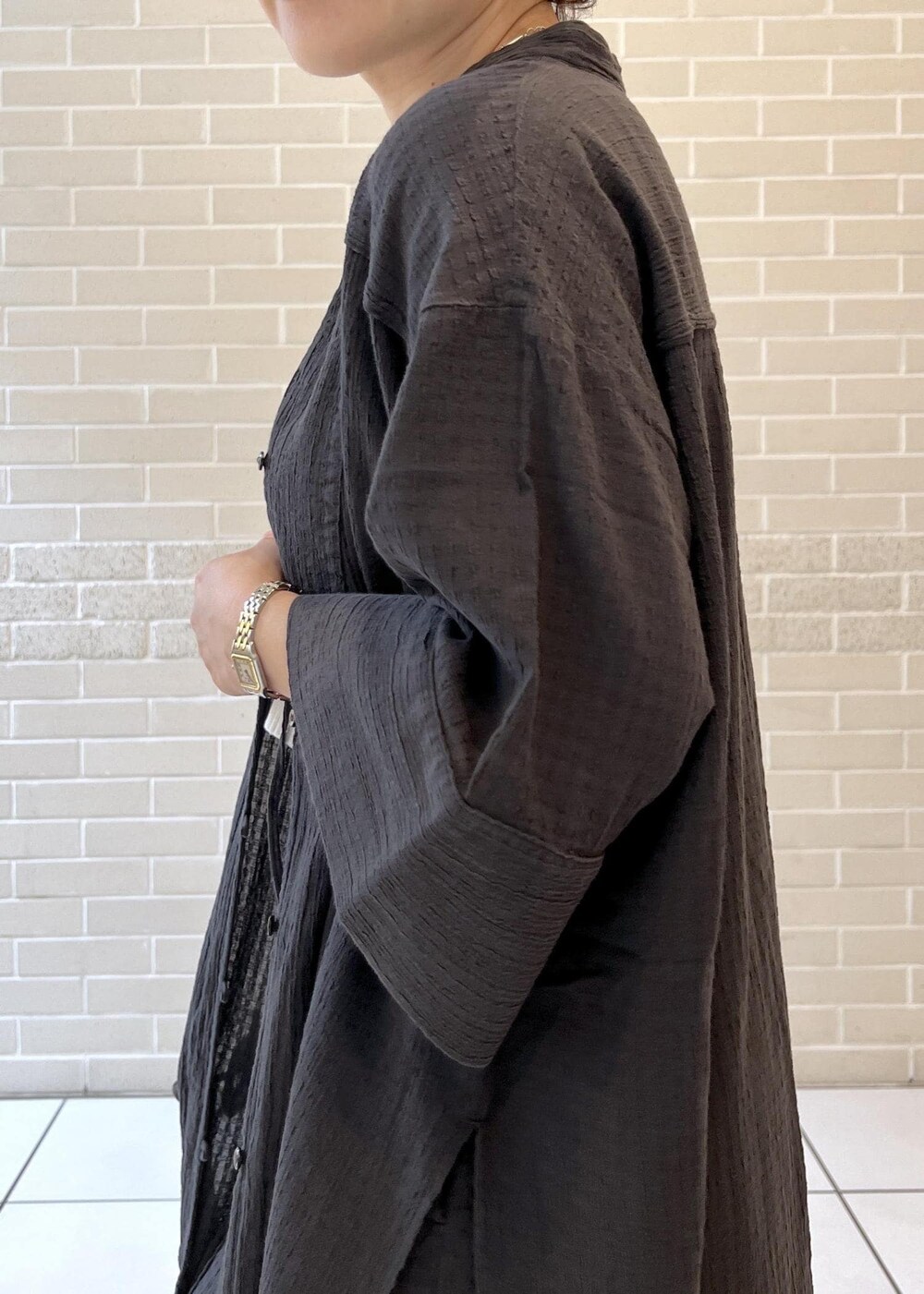 ホワイト系のチューブトップ、ベージュ系のサンダル、ブラック系のシャツ/ブラウスを着用したレディースの夏コーディネートの6枚目の写真