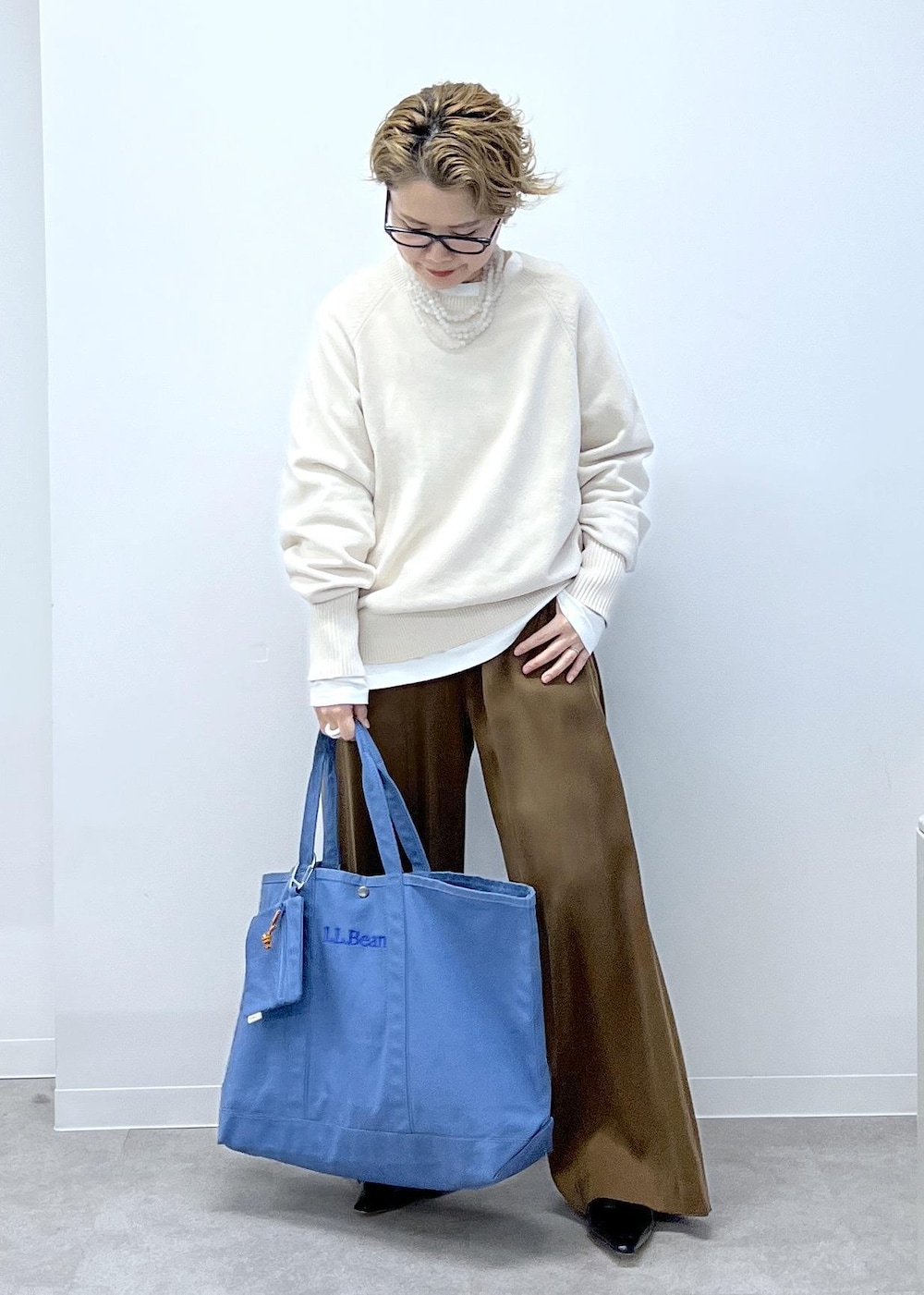 ホワイト系のスウェット、ブラウン系のその他パンツ、ブラック系のローファーを着用したレディースの秋コーディネートの4枚目の写真