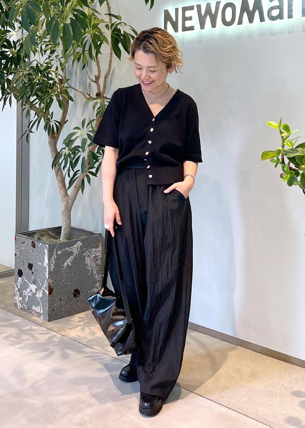 ブラック系のその他パンツ、ブラック系のローファー、ブラック系のショルダーバッグを着用したレディースの夏コーディネートの2枚目の写真