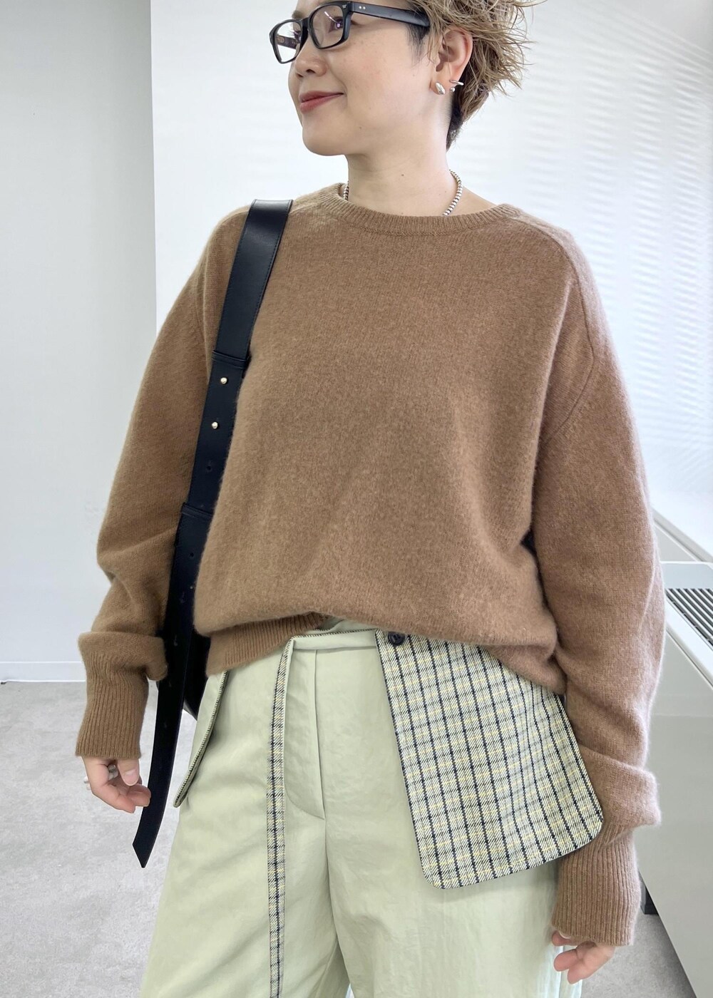 ブラック系のショルダーバッグ、ブラウン系のニット/セーターを着用したレディースの秋コーディネートの5枚目の写真